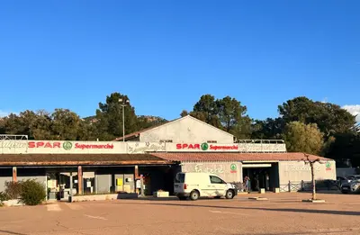 a white van parked in front of a building at Charmant 2 pièce tout équipé climatisé in Sainte-Lucie de Porto-Vecchio