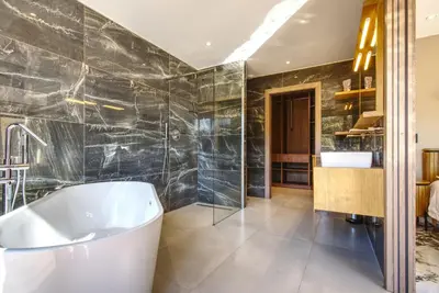 a bathroom with a large tub and a shower at La Villa Luxury Green patio in Cirendinu