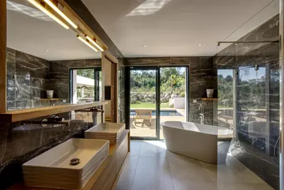 a bathroom with a tub and a large window at La Villa Luxury Green patio in Cirendinu