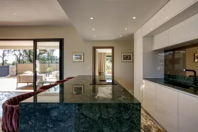 a kitchen with a large marble counter top at La Villa Luxury Green patio in Cirendinu