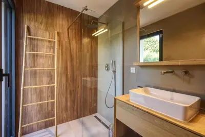 a bathroom with a sink and a shower at La Villa Luxury Green patio in Cirendinu
