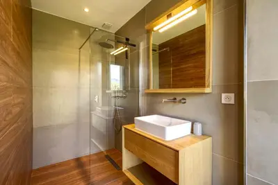 a bathroom with a sink and a shower at La Villa Luxury Green patio in Cirendinu
