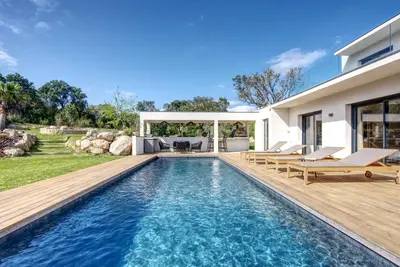 a swimming pool in the backyard of a house at La Villa Luxury Green patio in Cirendinu