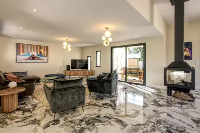 a living room with couches and a fireplace at La Villa Luxury Green patio in Cirendinu