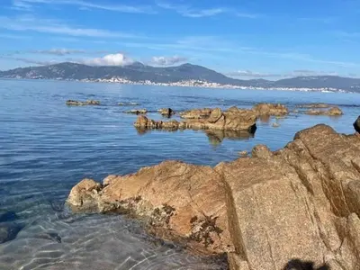 a large body of water with rocks in the water at A Nepita - 150m de la plage in Pietrosella
