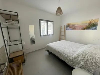 a bedroom with a bed and a ladder at A Nepita - 150m de la plage in Pietrosella