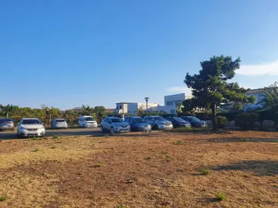a group of cars parked in a parking lot at La BénéCIOLA, vue Mer, Box Fibre SFR, High Speed Internet in Cervione