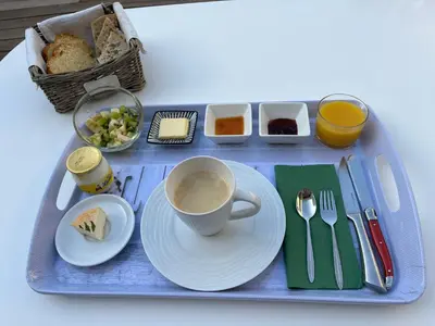 a tray with a cup of coffee and a plate of food at A Felicità in Sainte-Lucie de Porto-Vecchio