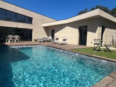 a swimming pool in front of a house at A Felicità in Sainte-Lucie de Porto-Vecchio