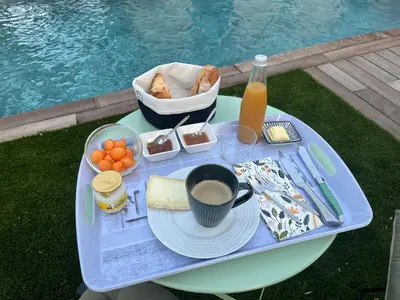 a picnic table with a tray of food and a drink at A Felicità in Sainte-Lucie de Porto-Vecchio