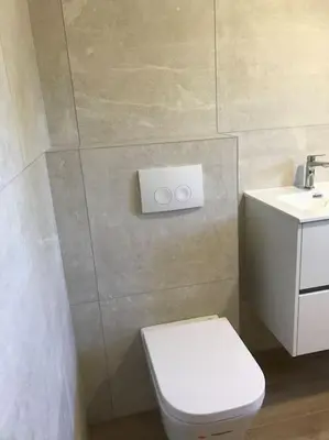 a bathroom with a white toilet and a sink at Studio bord de mer in Lecci