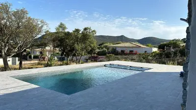 a swimming pool in the middle of a yard at Villa Bavella in Zonza