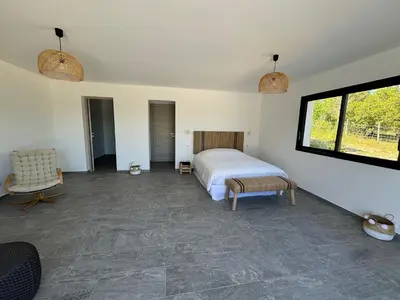 a bedroom with a bed and a window at Villa Bavella in Zonza
