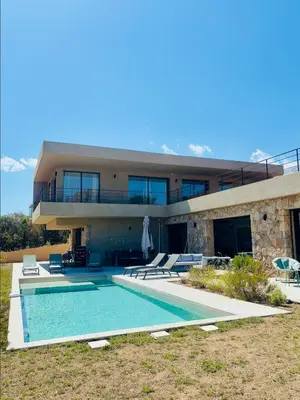 a house with a swimming pool in front of it at Casa Vitalba in Zonza