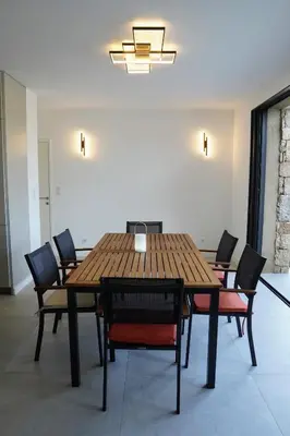a wooden table and chairs in a room at Casa Vitalba in Zonza