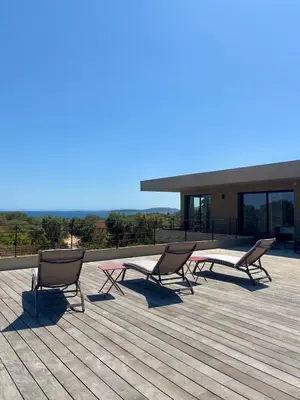three chairs and a table on a deck at Casa Vitalba in Zonza