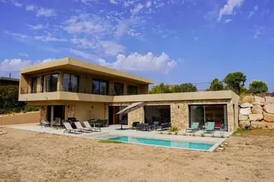 a large house with a swimming pool in front of it at Casa Vitalba in Zonza