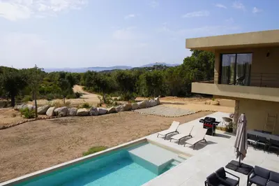a house with a swimming pool and a patio at Casa Vitalba in Zonza