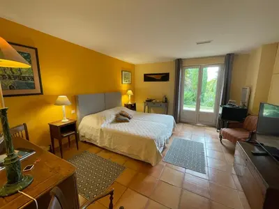 a bedroom with a bed and a tv in a room at Villa L'usciata in Pietrosella