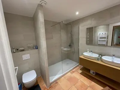 a bathroom with a shower and a toilet and a sink at Villa L'usciata in Pietrosella