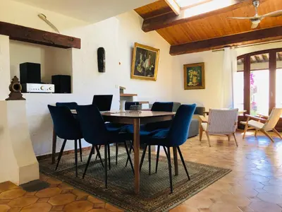 a dining room with a table and chairs at Casa Scaglione in Porticcio
