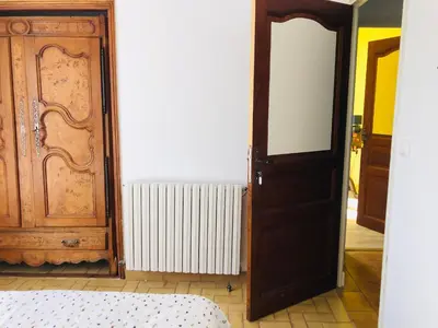 a room with a door and a bed and a radiator at Casa Scaglione in Porticcio