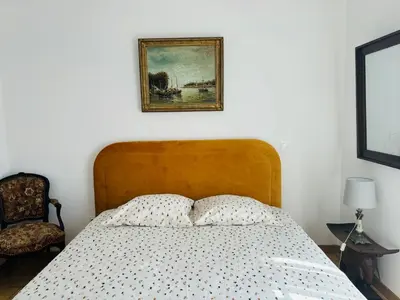 a bedroom with a bed and a picture on the wall at Casa Scaglione in Porticcio