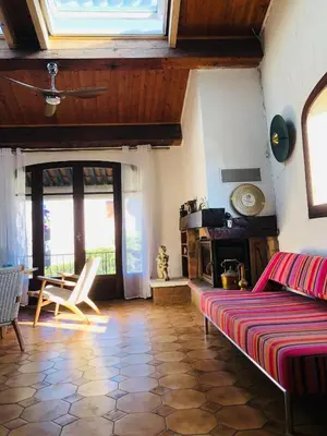 a living room with a bed and a table and chairs at Casa Scaglione in Porticcio