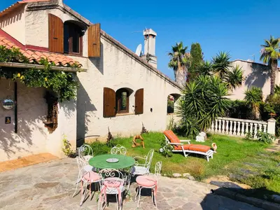 a patio with a table and chairs in front of a house at Casa Scaglione in Porticcio