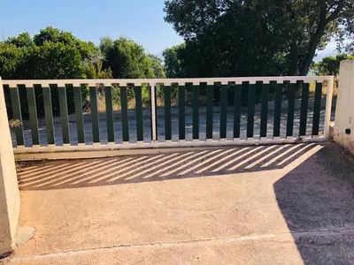 a wooden bench sitting in front of a fence at Casa Scaglione in Porticcio