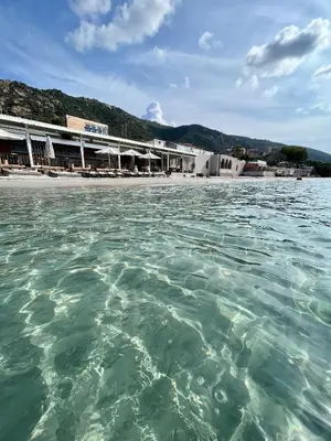 a building on a beach next to the water at Studio front de Mer Sanguinaires in Ajaccio