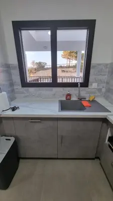 a kitchen with a sink and a window at Bel Appartement F3 proche de la plage in Pietrosella