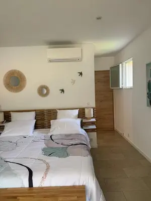 a bedroom with a large white bed with stars on the wall at Résidence Patios di Pruno in Figari