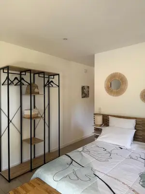 a bedroom with a bed and a book shelf at Résidence Patios di Pruno in Figari