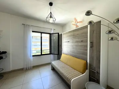 a room with a yellow bench and a window at Joli T2 idéalement situé in Propriano