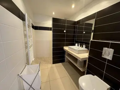 a black and white bathroom with a toilet and a sink at Joli T2 idéalement situé in Propriano