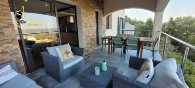 a patio with a table and chairs on a balcony at O SOHNO 4 pers vue Mer Piscine in Sainte Trinité