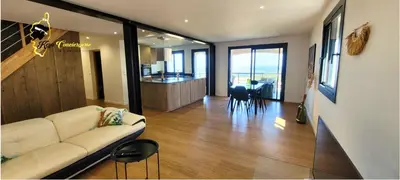 a living room with a white couch and a kitchen at O SOHNO 4 pers vue Mer Piscine in Sainte Trinité