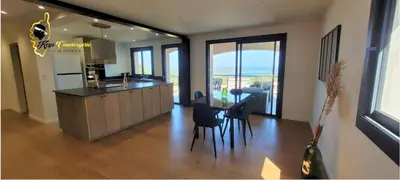 a kitchen and dining room with a table and chairs at O SOHNO 4 pers vue Mer Piscine in Sainte Trinité