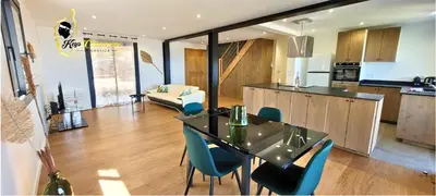 a kitchen and living room with a table and chairs at O SOHNO 4 pers vue Mer Piscine in Sainte Trinité