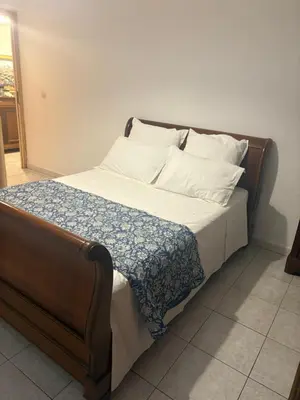 a bed with white sheets and pillows on it at Entre mer et maquis- maison avec piscine privée - 8 minutes plage tizzano in Sartène