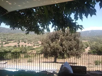 a person sitting on a bench looking out at a view at Entre mer et maquis- maison avec piscine privée - 8 minutes plage tizzano in Sartène