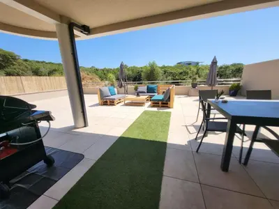 a patio with a table and chairs at Porticcio - Agosta Plage - T2 - Chez Cath et JC in Albitreccia