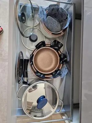a refrigerator filled with plates and pans at Porticcio - Agosta Plage - T2 - Chez Cath et JC in Albitreccia