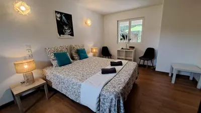 a bedroom with a bed with blue pillows on it at Casa di leo in Figari