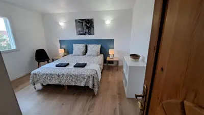 a bedroom with a bed and two lamps in it at Casa di leo in Figari