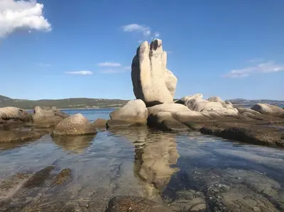 a rock formation in the water on a beach at Casa di leo in Figari