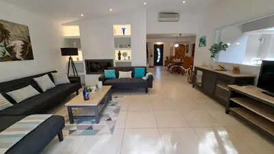 a large living room with couches and a tv at Casa di leo in Figari