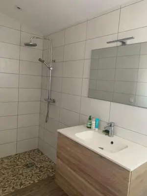 a bathroom with a sink and a mirror at La campagne au bord de la mer in Porto-Vecchio