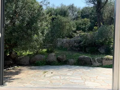 a bunch of rocks and a stone wall at La campagne au bord de la mer in Porto-Vecchio